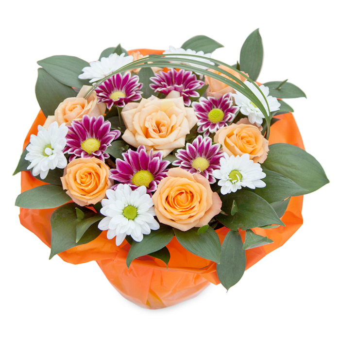 This vibrant hand-tied bouquet, as seen from a gentle overhead perspective, showcases the artistic sensibility found among Highgate's flower shops. At its core, roses in a seamless gradient from soft peach to radiant orange reflect the warm tones of autumn leaves along Highgate Wood's secret paths. Tucked between these focal blooms are white daisy-like chrysanthemums with fresh green eyes, glowing with purity, and dramatic magenta-purple counterparts whose dense petals surround vivid lime centers-offering a compelling contrast reminiscent of Highgate's mix of tradition and creative spirit. Abundant, glossy green foliage, evocative of the lush canopies around Lauderdale House gardens, creates a robust frame for the vivid center. Floating above, a slender, arching strand of vivid bear grass interplays with the organic forms below, introducing a dance of light and shadow. The bouquet's presentation is completed by a crinkled wrap of translucent orange cellophane, drawing out the bouquet's warmth and gifting intent-ready to bring light to celebrations, express gratitude, or simply brighten a loved one's morning in the heart of Highgate. This floral composition is both a testament to the local artistry and a celebration of community moments.