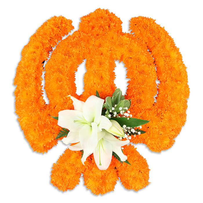 Centered on a crisp white field, this striking floral Ik Onkar-'Ik Onkar,' the Sikh declaration that God is One-is entirely formed from thousands of vivid orange marigold blooms. The arrangement maps the Ik Onkar's flowing numeral and crescent-like extensions with meticulous density: each marigold is placed to preserve the symbol's distinctive lines so the warm saffron surface reads cleanly from a short distance and in close-up reveals a tactile, velvety texture. At the lower centre of the symbol a cluster of pristine white lilies offers a serene counterpoint; two or more fully unfurled lilies show their soft, sculptural petals and pale green-yellow stamens, while smaller buds and stems suggest life and continuity. Pointed green foliage-chosen for its glossy, structural tone-surrounds the lilies, and fine sprays of baby's breath thread through the orange, adding pale punctuation and depth. A subtle drop shadow beneath the piece gives the impression of a solid, ceremonial badge rather than a flat graphic, ideal for placement in a temple doorway, community event, or a respectful household shrine. The overall impression is one of devotion made visible: the bright, celebratory orange paired with the cool purity of white expresses unity, reverence, and the soft ritual of offering flowers. As someone who works in Highgate and knows the feel of local observances from Highgate Hill to nearby Hampstead, I imagine this piece carried or displayed with care during Guru Nanak Jayanti, Vaisakhi, and other moments of communal remembrance.