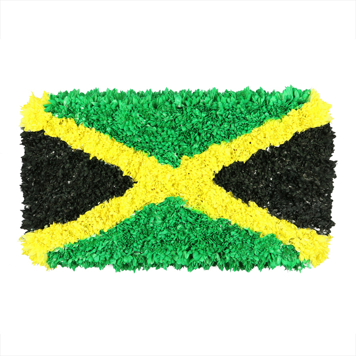 This unique Jamaican flag, rendered as a densely textured collage, is a testament to craft and community found in Highgate. The flag's central gold saltire slices the composition diagonally, its edges formed by countless small, crumpled pieces of material-tissue, fabric scraps, perhaps even reclaimed packaging-stitched together into a springy, three-dimensional surface. The top and bottom triangles glow with vibrant emerald green, each fragment catching daylight and casting a mosaic of greens. The left and right triangles are deep black, with each piece presenting its own tiny shade and crease, giving the piece an earthy, almost velvet-like lustre. The result is a tactile, sculpture-like flag that stands away from the white page, inviting viewers to feel the texture with their eyes. In the gaze of a Highgate audience, this image reads as a celebration of heritage and artful resilience, a modern interpretation of Jamaica's symbols reframed through craft and sustainability. If you're seeking a visual that connects cultural pride with local artistry, this work fits nicely beside stories about Jamaican celebrations, diaspora communities, or pop-up art in North London, where a florist like Flowers Highgate often draws inspiration from colour, texture, and community ties. Presented here in Highgate's light, it becomes more than decoration-it's a small shared memory, a conversation starter about Caribbean roots and London life, and a reminder that craft and care can turn everyday materials into something celebratory and enduring.