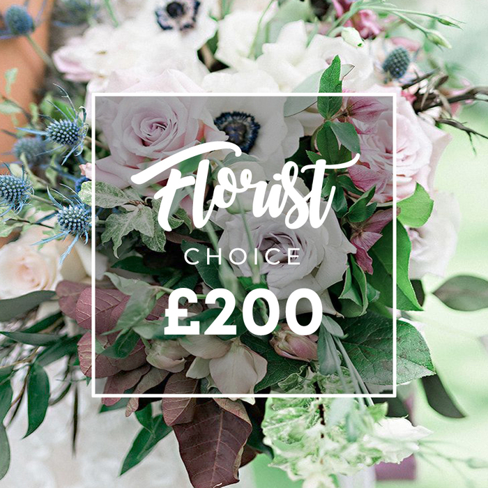 An opulent Florist Choice bouquet priced at ?200 from Flowers Highgate is presented in a close-up that invites touch and memory. The pastel and muted palette is led by open light pink garden roses, white anemones with near-black centers, and pale lavender-grey roses, offset by spiky blue eryngium and burgundy leaves. The greens include slender eucalyptus and deep burgundy foliage, creating movement and depth. The arrangement appears natural as if gathered from a quiet Highgate garden near Highgate Street or Hampstead Heath, then artfully arranged with deliberate rhythm. The central overlay displays Florist CHOICE and ?200, anchoring the image as a designer service. This bouquet would shine as a wedding centerpiece or a refined birthday gift, its colours echoing soft dawns and twilight sophistication. Its texture-silky petals against crisp thistles and woolly leaves-offers a tactile sense beyond the frame. The background, a blur of natural light, suggests a setting both intimate and expansive-perhaps a garden terrace in Highgate or a sunlit conservatory in Crouch End. Delivered with care by a local florist who knows the community, it promises freshness, reliability, and a personal touch for those celebrating life's moments.