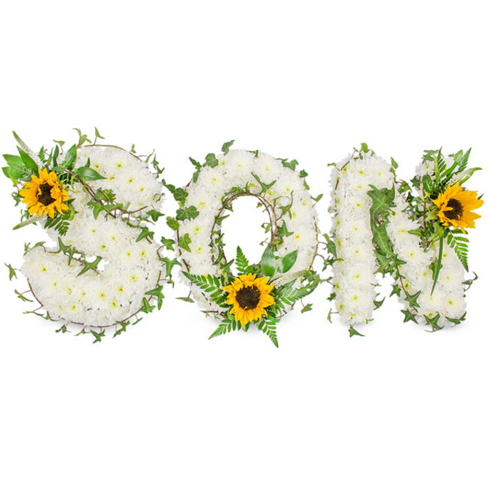 A three-dimensional memorial arrangement spells out SON in block capitals, each letter densely covered in tiny, immaculate white chrysanthemums that create a pillowed, tactile surface. The chrysanthemums are arranged so closely their rounded heads form a continuous, soft plane interrupted by the dark, glossy coils of ivy that meander through the letters; the ivy's deep green leaves and twisting stems give a reassuring sense of continuity and life. Interspersed fern fronds and slimmer greenery add lighter green highlights and delicate texture, filling pockets within the O and along the inner curves of the S and N. Strategic pops of colour come from three large sunflowers-broad, sunflower-yellow petals encircle rich dark brown centres-placed deliberately for visual balance: one tucked into the S's upper-left curve, another settled at the lower arc of the O among the ferns, and a third crowning the upper-right limb of the N. The composition sits against a stark white photographic background with soft directional lighting that accentuates the chrysanthemums' creamy tones, the sunflowers' warmth, and the foliage's varied greens, while casting minimal, gentle shadows to emphasise form. The effect is both elegiac and quietly uplifting: white blooms for peace, ivied greens for enduring memory, and sunflowers to suggest light and cherished recollections. This bespoke tribute is particularly fitting for memorials in the Highgate area-thoughtful for a service near Highgate Cemetery, a chapel in Highgate Village, or a family gathering overlooking Waterlow Park-and reflects the care of an experienced florist in arranging personal, meaningful funeral flowers.