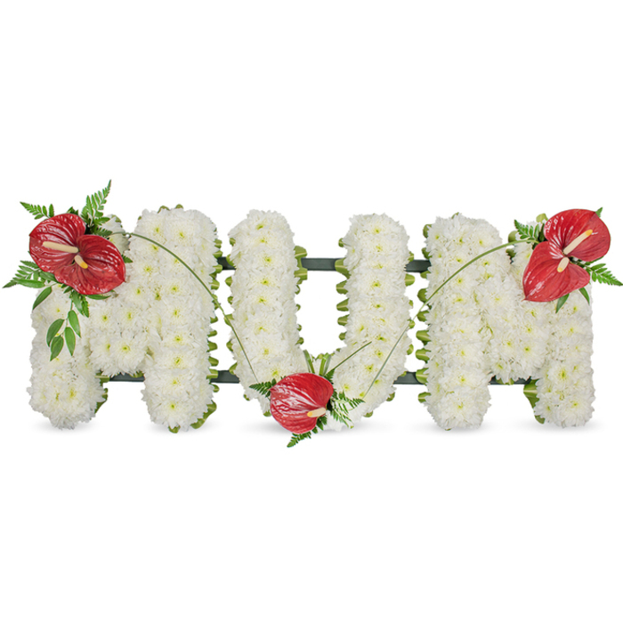 A poignant floral memorial spelling MUM, hand-assembled from hundreds of pristine white spray chrysanthemums packed densely so the letters read with gentle volume and a soft, tactile surface. The flowers' small round faces create an even, cloud-like plane while a dark green structural frame - visible only as a calm outline - gives the freestanding letters their clean edges. Three striking red anthuriums provide the arrangement's focal warmth: one positioned on the upper left arc of the first M, another nestling into the lower curve of the U, and a third placed on the upper right of the final M. Each anthurium's glossy spathe and pale yellow-white spadix offers a luminous counterpoint to the matte chrysanthemums, and the waxy texture of the red blooms is offset by clusters of fern fronds and broader leaves that add shadow, richness and a sense of woodland freshness. Slender, arching blades of grass or stems drift between the red accents, visually linking the letters like a soft green ribbon and giving movement to an otherwise serene piece. Crafted with the restraint and care of a local florist, this classic sympathy tribute conveys deep respect and tender remembrance - suitable for a funeral, wake, or graveside service near Highgate Cemetery or along Archway Road. At Flowers Highgate we would present it in soft daylight so the colours remain true and the textures comfort those gathering to remember a beloved mother.