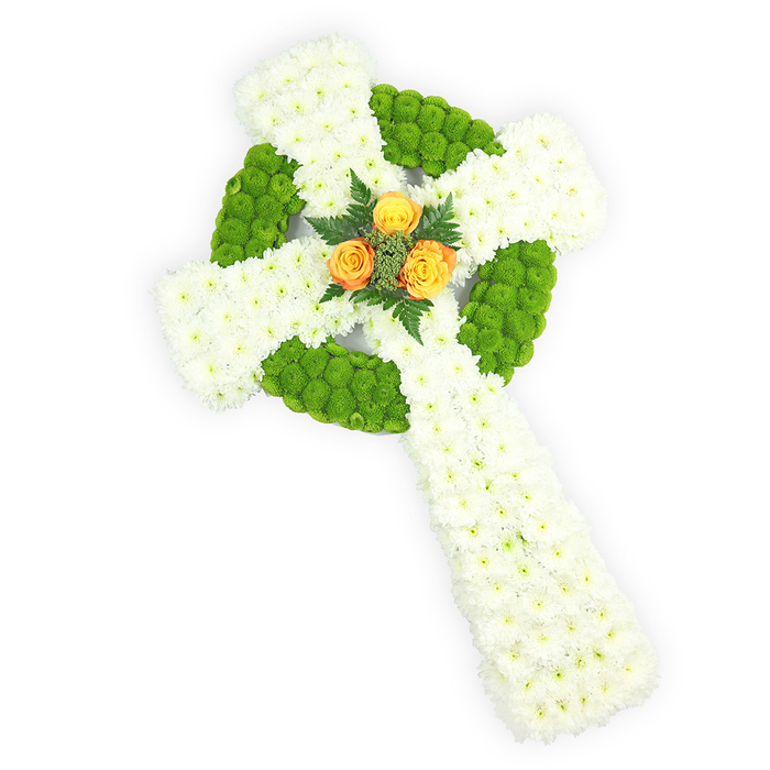 A striking, reverent floral Celtic cross, photographed from a gentle overhead angle against a bright white background, crafted with the kind of attention to detail we hold at Flowers Highgate. The cross's form is formed almost entirely of small, pure white spray chrysanthemum blooms, packed densely to create a soft, cloud-like surface across the arms and long shaft; the even, diffused lighting accentuates the tiny petal edges and the plush depth of the massed flowers. Bright lime-green button chrysanthemums are used with graphic intent: they trace the circular boss at the arms' intersection and appear in alternating sections along the horizontal arms, their rounded, compact heads giving delightful texture and a modern contrast to the whites. At the heart of the cross a trio of vibrant orange-yellow roses is nestled, their fully opened, warm petals serving as a tender focal point that seems to lift the arrangement's expression from solemn to gently hopeful. Slim, dark green fern sprigs frame these roses, introducing a verdant line that increases dimensionality and a quiet botanical scent when handled in person. The palette of white, green and orange subtly echoes the Irish tricolour, making the tribute especially resonant for services at Highgate Cemetery or St. Joseph's Church, or for families wishing to honour Irish roots. The composition balances sculptural clarity with floral softness: it reads as both a formal memorial and a personal emblem of faith and memory. Presented plainly so every stitch of flora is visible, the piece is suited for graveside, chapel, or funeral home placement, and its craftsmanship reflects a local sensibility familiar to neighbours around Highgate Village and Waterlow Park.