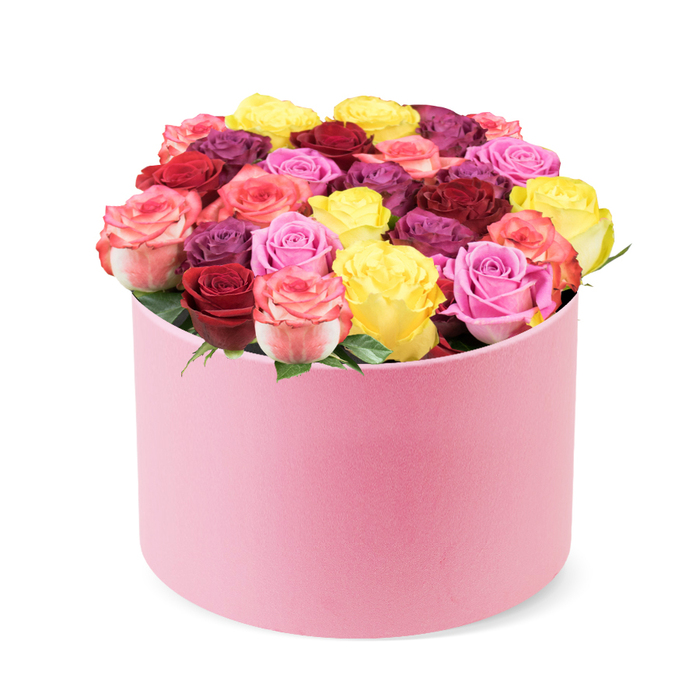 From a corner of Highgate Village, this stunning floral arrangement arrives in a soft pink, round hat box, the velvet-like material catching the light as if dolloped with morning dew. The cylindrical box cradles a dense, domed bouquet of roses-thirty to forty blooms arranged with the confidence of a master florist. The palette reads like a celebration: sunny yellow, deep red and burgundy, a spectrum of pinks from soft blush to vibrant fuchsia, creams, and even regal purple-plum hues peeking through. Each rose unfurls with tightly packed, velvety petals, signs of peak freshness and meticulous care. A few bright green leaves provide a natural frame, ensuring the colors pop without overwhelming the eye. This presentation speaks of luxury retail-grade quality while remaining warmly giftable for special occasions-Valentine's Day, anniversaries, birthdays, Mother's Day, or a simple gesture to say you care. The arrangement sits proudly as a gift in transit, and our delivery service covers Highgate, Hampstead Heath area and beyond, ensuring the box arrives pristine for the moment of celebration. The design suits modern interiors and traditional mantels alike, and its combination of bold colors with a soft pink container makes it an elegant focal point for a room. Created by Flowers Highgate with a devotion to freshness, texture, and lasting beauty, this piece embodies love, gratitude, and joyful generosity.