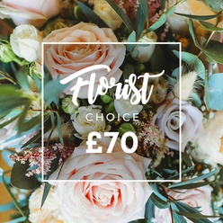 Seen from above in soft, morning light, this Florist Choice bouquet is a study in gentle contrasts: large, full roses in blush pink, creamy white and soft peach unfurl with layered petals, while smaller, muted lavender or dusky mauve roses provide a whisper of shadowed colour. Interlaced between the roses are cloud-like clusters of tiny white filler blooms and minute pink waxflower buds that create a delicate, lace-like texture, alongside feathered dried stems and cream-tan seed heads that give the arrangement airy depth and a subtle countryside warmth. The composition is threaded with rounded eucalyptus leaves - dusty, bluish-green and supple - which lift the scent and add structural rhythm. A crisp white rectangular frame overlays the center of the image, framing a graceful script that reads Florist Choice, with CHOICE set below in a neat sans-serif and the price ?70 shown prominently at the bottom in bold white numerals. As a Highgate florist I picture this bouquet on a mantel in Highgate Village or delivered through Waterlow Park for a quiet celebration; it carries the soft perfume of roses and the dry, papery note of preserved grasses, offering an approachable elegance that suits birthdays, anniversaries or a comforting 'thinking of you' delivery. Available from Flowers Highgate for local hand-delivery, this image communicates the tactile contrasts and expert selection behind a signature florist's pick without sacrificing the natural, slightly wild charm of garden-style arranging.