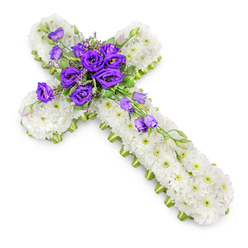 A carefully crafted funeral cross arrangement, reminiscent of those seen at memorials near Highgate Cemetery and local churches, is shown from above against a completely white background. The cross is densely packed with white spray chrysanthemums, each small flower set closely against the next, forming a uniform, cushion-like surface that looks both soft and immaculate. Their petals are crisp and bright, and the faint hint of green at the centre of each bloom brings a quiet liveliness to the otherwise pure white field. Framing the cross is a slim border of lime-green ribbon, its satiny texture catching the light and neatly outlining the shape, much like the vibrant green edges of Highgate's garden squares in spring. At the heart of the cross, where the arms intersect, a lush cluster of deep purple lisianthus draws the eye. These velvety blooms are full and layered, their rich tone providing a powerful contrast against the white chrysanthemums and suggesting reverence, sorrow, and enduring devotion. Interlaced among the purple flowers are small sprigs of greenery and a few delicate filler blossoms, giving the central cluster depth and a slightly untamed, natural grace. From this focal point, lisianthus stems trail gently down the lower-right arm, carrying a mixture of open flowers and tightly closed buds that hint at ongoing life and hope. Soft, even lighting illuminates the arrangement, and a gentle shadow beneath the cross gives it dimension, as though it is resting quietly on an altar or table. The overall impression is of a serene, faith-inspired sympathy tribute, something a skilled Highgate florist might prepare to help a family honour their loved one with beauty and quiet strength.