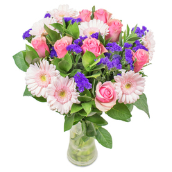 As I compose this bouquet in Highgate, I'm constantly inspired by the soft interplay between pastel gerberas and classic roses-their blush-pink tones coming together like the first rays streaming across Hampstead Lane in spring. Each bloom's gentle shade blends seamlessly, with playful streaks of deep purple statice woven throughout, creating a striking rhythm against the airiness of the arrangement. The foliage is fresh and cool, reminiscent of the lushness found along Highgate Wood's paths, grounding the vibrant heads above. Light, uplifting, and filled with optimism, the bouquet evokes the freshness of a bright morning and the tranquillity unique to Highgate. Its glass vase is an understated frame, enhancing the sense of local elegance and sincerity. Whether serving as a get-well gesture or an accent in a sunlit drawing room, every detail has been arranged by artisans at Flowers Highgate, ensuring each creation carries the joy and skilled touch that define our neighbourhood's floristry.