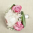 This bouquet is a poem of romance and delicacy, woven for special moments in the heart of Highgate. Three pink roses bloom in vivid gradients, outer petals shaded in bold magenta gently blending toward softer blush and muted lavender within, each unfurling with confident artistry. Anchored amidst them is a plush, full white peony-its abundant ruffled petals filling the arrangement like fresh morning mist on Highgate's leafy lanes. Wisps of baby's breath wind among the larger flowers, their tiny, cloud-like clusters sprinkling airy purity across the bouquet. Surrounding all, wide, glossy deep green leaves form a gracefully structured base, exuding vibrant energy and echoing the natural green spaces of Highgate Wood. The stems are neatly gathered and bound in luminous white satin ribbon, forming a handle that suggests both purpose and care. Set on a neutral linen background, the bouquet is softly lit, allowing colours to glow and textures to take centre stage. With each element thoughtfully chosen and arranged, this bouquet becomes the embodiment of new beginnings, affection, and artistry-ideal for a local wedding, a cherished anniversary, or as a meaningful gesture delivered from Flowers Highgate.