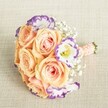 From an elevated vantage, this meticulously styled bouquet rests atop a creamy, textured linen background-radiating quiet sophistication for Highgate's special events. The roses, abundant and open in dreamy tones of peach, apricot, and soft pink, form the heart of the arrangement, their petals glowing as if touched by morning light streaming through the windows of historic Highgate homes. White lisianthus with dramatic violet-tinged edges weave through the bouquet, offering a playful, modern contrast that echoes the area's artistic flair. Wispy baby's breath gently fills the spaces, adding a cloud-soft texture and classic romantic touch. The compact, rounded arrangement is hand-tied with a peach-pink satin ribbon, accented by dainty pearl beads for added luxury. This bouquet by Flowers Highgate is perfect for weddings, bridal parties, or as a refined centrepiece for occasions throughout N6. Each bloom is selected with expertise and care, offering Highgate residents a fresh, fragrant, and beautifully balanced floral creation that brings a sense of joy and timeless elegance to any celebration.