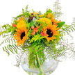 There is a rush of sunshine in this arrangement-created for same-day delivery throughout Highgate-anchored by bright, jubilant sunflowers with wide golden petals encircling deep brown centres. Their powerful presence fills the bouquet with cheer, softened by clouds of pale yellow roses that nestle gracefully at their side, radiating a creamy, gentle light. Sprigs of vivid, coral-orange berries and small blooms are woven through the design, lending an urban edge inspired by Highgate Village's creative vibe. Green fern fronds cascade outward, their fine, feathery detail framing the ensemble much like the woodlands surrounding Hampstead Heath. A mix of eucalyptus and lime-green foliage adds modern, textured accents-the scent crisp and refreshing, like washed air after summer rain. The sturdy, globe-like glass vase showcases every green stem, immersed in water for an utterly fresh look. This bouquet feels alive with late August energy and warmth, perfect for birthdays, new beginnings, or simply brightening a North London home. Every aspect-colour, movement, scent, and composition-embodies the heartfelt spirit and artistry of Highgate's community florists.