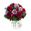 A dense, rounded bouquet of freshly cut roses where deep crimson and warm burgundy blooms sit cheek-by-jowl with soft lavender and dusty lilac roses, each blossom fully open with layers of unfurling petals that catch the light. Dark, glossy foliage-Ruscus or salal-sits beneath and between the heads, giving the bouquet a cool, verdant backdrop and a subtle rustle when moved. Scattered through the composition are small, bright red-orange rose hips, their glossy, berry-like skins adding a cheerful, autumnal flash and a hint of rustic texture against the velvety rose petals. The flowers are gathered in an antique-style mercury glass vase: rounded and bulbous at the base, tapering slightly at the neck, its silvered, mottled finish reflecting soft highlights and lending the arrangement a quietly vintage elegance. A length of natural raffia or twine is tied around the vase's neck, and a rectangular white gift tag hangs forward, pinned with a small stylized rose graphic and a line of green script, suggesting a personal message. Photographed on a brilliant white background, the saturated reds and muted purples read clearly and feel immediate-romantic, thoughtful, and refined. The scent is imagined as a gentle, sweet rose perfume with a green, leafy undernote; the petals look soft to the touch while the berries give a firmer contrast. This bouquet reads as a sophisticated gift for anniversaries or quiet celebrations, a floral statement that balances lush romance with a hint of countryside charm-perfect for leaving at a loved one's doorstep or placing on a candlelit table as a lasting impression.