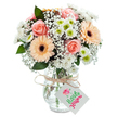 A striking bouquet arranged by an experienced Highgate florist, capturing the quiet sophistication of Hampstead Heath's borders. Plump, peach-tinged roses form a romantic focal point, their petals unfolding in soft spirals, while lively peach gerbera daisies-with rich brown centers-lend whimsy and fresh energy to the ensemble. Interspersed throughout, snowy clusters of baby's breath fill the arrangement with gossamer lightness, their tiny blossoms reminiscent of a late spring morning. White chrysanthemums with lively, bright green hearts provide texture and a gentle play of colour, weaving in freshness that feels as airy as the gardens along Highgate Hill. The entire bouquet is anchored in a pristine clear glass vase, with lightly patterned sides reflecting gentle natural light, its base bulbous and tapering towards the neck for a modern yet timeless look. A length of rustic twine is tied at the vase neck, holding a crisp white tag-a touch of handcrafted charm ready to carry your personal message. Every detail, from the visible waterline to the interplay of pastel hues, speaks of care, artistry, and the simple joys of giving flowers within the Highgate area. This arrangement is perfect for conveying affection, celebrating life's milestones, or offering thoughtful encouragement, and is available for same-day flower delivery to homes and offices throughout N6 and North London's leafy neighbourhoods.
