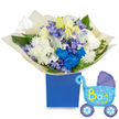 A tender, celebratory still life: a lush, rounded bouquet sits in a matte royal-blue presentation box, its dense cluster of blooms arranged to read as a soft lullaby in colour and texture. At the heart, creamy-white roses nestle beside ivory lilies - some just unfurling with pale yellow stamens peeking out - and full, cushiony white chrysanthemums that give the composition a calm, classic base. Scattered through the arrangement are electric cobalt chrysanthemums that catch the eye like joyful exclamations, while sprays of soft lavender or periwinkle bell-shaped flowers - reminiscent of hyacinths - add a powdery, spring-like touch. Fresh green foliage, from broad glossy leaves to feathery fern fronds, frames each blossom and lends a cool, natural backdrop. The stems are gathered and wrapped in crinkled cream tissue paper, the tactile folds softening the box's clean edges and suggesting the careful hands that tied it. To the right, a pale blue foil balloon shaped like an old-fashioned baby carriage floats slightly, its canopy and wheels detailed in darker blue with tiny polka dots and hearts, and the cheerful phrase It's a Boy displayed in playful yellow-green lettering across the side. Soft daylight falls on the composition, revealing the subtle sheen of the balloon and the velvet petals of the lilies, while a faint green scent of leaves and lilies seems almost audible. This is a refined newborn gift - perfect for a hospital welcome, a sunny baby shower in Highgate Village, or to leave by the door when visiting new parents home from the birth. The overall impression is one of careful craftsmanship, gentle joy, and the cool, comforting blues and whites of a traditional welcome baby boy bouquet.