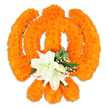 A reverent, freestanding floral Khanda rests against a pristine white backdrop, its form lovingly sculpted from hundreds of bright orange marigold heads. The marigolds are packed close together to build the Khanda's circular chakkar, the paired crossed kirpans and the central double-edged khanda, their velvety petals catching a soft studio light that gives the symbol a warm, almost glowing texture. At the precise centre, where the swords meet, a small cluster of pristine white lilies is set like a calm heart: at least two fully open lily blooms display gently curving petals and pale green-and-yellow stamens, surrounded by a few smaller unopened buds. Glossy, deep-green foliage-the kind of pointed salal or laurel leaves we often choose for structure-frames the lilies, while delicate sprays of snow-white gypsophila weave through the orange field, softening the edges and adding air and depth. A subtle drop shadow beneath the arrangement suggests a solid, three-dimensional piece, suitable for placing on a ceremonial table or in a community hall. The overall palette-festive saffron-orange balanced with serene white and cool green-carries both celebration and quiet devotion, evoking Vaisakhi processions, Gurpurab remembrances, or floral tributes in local Gurdwaras across North London. The composition is tactile and fragrant in the imagination: the sweet, warm scent of marigold mingling with the fresher, green perfume of lilies and foliage. As a floral artist familiar with Highgate's sensitive sense of tradition, I see this piece as both an offering and a statement of cultural respect, created to honour ceremony while speaking to the eye and the heart.
