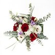 A lush, hand-crafted bouquet is shown from a perfectly overhead angle, floating against a pure white background so every flower and texture stands out clearly. At the heart of the design, velvety red roses cluster together, their petals tightly layered and full, radiating a sense of classic romance and quiet intensity. Around them, crisp white gerbera daisies with dark, chocolate-brown centres create a strong, graphic contrast, almost like little suns orbiting the roses. Between these larger blooms, clouds of tiny white spray chrysanthemums fill the gaps, adding a soft, cushion-like texture that makes the bouquet feel generous and full. Here and there, pale lilac lisianthus blossoms curl in gentle, bell-shaped whorls, their cool lavender tones bringing a restful balance to the bold reds and clean whites. Encircling the bouquet, long stems of silvery-green eucalyptus spread outward, their round, coin-like leaves catching the light and giving the arrangement a modern, airy outline. Slender green foliage threads through the design, giving depth and a sense of gentle movement, as though the flowers have just been gathered fresh from a garden walk on a calm Highgate morning. The lighting is bright and even, with no harsh shadows, so every vein in the leaves and every petal edge is clearly visible, emphasizing freshness and meticulous floristry. This overhead composition feels both luxurious and welcoming, the kind of bouquet you might place at the centre of a winter anniversary supper on a Highgate Village dining table or send as a thoughtful gesture to a friend living near Waterlow Park, carrying with it the subtle fragrance of eucalyptus and the timeless message of red roses and white blooms working in perfect harmony.