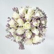 A sense of effortless tranquillity defines this bouquet-it captures the serene mornings of Highgate in refined floral form. At the centre, crisp white roses bloom luxuriously, each petal plush and enveloped in creamy spiral layers, evoking new beginnings and quiet hope. Interlaced throughout are sprays of pale lavender statice, providing a delicate, lace-like counterpoint and softening the arrangement's clean lines. Gentle hints of green foliage peek through, suggesting the woodland allure of nearby Queen's Wood. The bouquet's freshness glows against a softly lit background, each detail illuminated by natural light pouring through a Highgate window. Radiating calm and understated elegance, this design is perfect for moments of support, tender celebrations, or as a lasting accent in a sophisticated Highgate home-its presence lingers, much like the faintest floral scent after a spring rain.