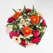 A jubilant celebration of colour and texture, this bouquet seems infused with the joy and artistry of Highgate's vibrant community. Radiant orange gerbera daisies command attention at the heart, catching the light just as the sun dapples through the trees of Waterlow Park. Around them cluster lush magenta carnations and delicately blushing pink roses, their plush petals rich and inviting. Sprays of snowy white alstroemeria and cheerful miniature daisies scatter a sense of freshness throughout the design-like early-morning dew gracing the lawns near Highgate's village square. Abundant yet perfectly balanced, the bouquet's glossy green leaves encircle each bright bloom, echoing the lush gardens of North Hill or Pond Square. The harmonious palette-at once vibrant and refined-radiates warmth, optimism, and the expert touch of Highgate's local florists. Whether destined for a birthday celebration, a heartfelt thank you, or simply to bring a burst of spring energy to a home on North Road, this bouquet delights the senses with its blend of gentle fragrance and radiant colour, capturing the hopeful spirit and enduring beauty of Highgate.