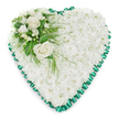 A calm and elegant heart-shaped tribute for a funeral or memorial service is presented on a spotless white background, letting its gentle details take centre stage. The heart itself is entirely filled with tightly packed white chrysanthemums, each small bloom nestled closely against its neighbours to form a smooth, cushion-like surface. This unbroken layer of white petals gives the arrangement a soothing, cloud-soft appearance, symbolising purity, peace, and loving remembrance. Around the perimeter, a rich emerald green satin ribbon has been pleated into soft ruffles, creating a scalloped edge that outlines the heart with quiet precision. The satin's faint shimmer offers a striking yet tasteful contrast to the velvety flowers, adding structure and refinement. In the upper left curve of the heart, a carefully placed cluster of feature blooms becomes the focal point. Two fully opened white roses, with petals unfurling in graceful spirals, sit at the centre, evoking tenderness and enduring affection. They are surrounded by smaller white blossoms, reminiscent of freesias or other airy flowers, which add delicate texture and a sense of lightness. A mix of deep green leaves and feathery, fern-like foliage cradles this cluster, with a few sprigs extending over the chrysanthemum base to blend the elements together in a natural way. This heart-shaped arrangement feels particularly suited to Highgate's character, something a family might choose for a service before walking through the area's tree-lined streets or nearby green spaces. It serves as a soft-spoken yet powerful expression of sympathy and tribute, offering comfort and a visual reminder of love that endures beyond loss.