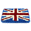 A broad, cushion-shaped Union Jack floral tribute fills the frame, its rectangular outline softened by a gentle dome of densely packed flowers. The deepest layer is formed by dark blue chrysanthemums, placed so tightly together that they create an unbroken sea of colour, like a velvet cloth spread carefully across a table. Over this base, crisp white flower heads trace the strong vertical and horizontal bands of the flag, then continue as narrow diagonal lines at the corners, giving the design a clean, architectural clarity. Inside these white outlines, rich red blossoms are grouped into bold, confident stripes that cut across the floral flag, their slightly ruffled petals and fuller heads lending extra height and texture. The combination of red, white, and blue is vivid yet harmonious, with each hue clearly defined but softened by the natural irregularity of petals and blooms. A wide, satin-like ribbon in matching deep blue wraps around the edge of the tribute, pleated into neat folds that frame the flowers and add a touch of formality, as though the piece has been dressed in ceremonial attire. The entire arrangement is photographed against a bright white background, which makes the colours appear especially clear and true. The effect is both moving and dignified, ideal for a military funeral, remembrance ceremony, or a farewell for someone with a strong sense of national pride. It is easy to picture this floral flag arriving at a Highgate service, perhaps at a chapel near Highgate Cemetery or on a quiet street off Swain's Lane, where local families gather to say goodbye and honour a life of commitment and service.