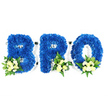 A studio-style, eye-level photograph on a pure white backdrop shows a three-part floral tribute forming the word BRO in bold, three-dimensional capital letters. Each letter is densely covered with royal blue chrysanthemum florets, their tiny petals packed so closely they read as a plush, velvety surface with defined edges and soft shadowing. Nestled at the lower edge of each character are small accent clusters of pale ivory or creamy yellow spray roses, some tight buds and some gently unfurling, paired with tiny white filler blooms and a mix of glossy green leaves and fern-like fronds. A thin white base or foam is just visible around the contours of the letters and within the loops of the B and R and the center of the O, hinting at the careful floral mechanics beneath the mass of blooms. The colour contrast is deliberate: the saturated blue evokes calm and remembrance, while the ivory roses offer a tender, consoling light. The arrangement reads as reverent and considered, the kind of personalised tribute families choose for a brother's funeral, wake or graveside service. You can almost sense a faint, comforting scent of roses under the cool, slightly herbaceous green, and the overall composition feels steady and respectful rather than ornate. As a florist who spends time arranging tributes for local Highgate services and walks through Highgate Cemetery and nearby Waterlow Park, I picture this piece laid near a service table or at a chapel entrance - a simple, heartfelt declaration of love and memory made with steady hands and quiet care.
