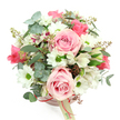 The scene shows a delicately styled hatbox flower arrangement set against a bright white background, giving it the clean, contemporary feel of a Highgate townhouse interior. The container is a round, blush pink hatbox, its pastel hue understated yet romantic. A thin ribbon of deeper pink satin encircles the box, tying the design together with a subtle gleam. Dangling from this ribbon is a small, cream rectangular tag, lightly printed with a logo or name that suggests the skilled hands of Flowers Highgate. Rising from the box, the bouquet forms an abundant, rounded canopy of blossoms. Soft pink roses are the most prominent, placed evenly across the top so that their velvety, spiralling petals create multiple focal points; some are wide and open, others just beginning to reveal their centres, conveying a sense of blooming over time. Tucked around them are white, daisy-like chrysanthemums, their green centres standing out vividly against the ivory petals, bringing brightness and an uplifted mood to the piece. between the larger blooms, slender white alstroemerias appear, each petal traced with delicate purplish-red streaks and freckles, offering intricate details that reward a closer gaze. Surrounding and supporting the flowers is an array of greenery: rounded eucalyptus leaves in a soft, silvery-green tone fan outward, their matte surfaces tempering the sweetness of the pinks and whites, while dark green, elongated leaves interlace through the stems, adding structure and contrast. Small clusters of reddish-brown buds or tiny berries nestle in the foliage, lending a hint of earthy warmth, reminiscent of the textures found along the paths of Highgate Wood. The overall impression is one of gentle elegance and warmth, a ready-to-display floral gift that would suit a birthday, a thank-you gesture, or an intimate celebration, delivered with care to homes and businesses across Highgate.