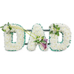 The photograph presents a traditional DAD funeral flower tribute, the kind of personalised piece often seen at services in and around Highgate. The three letters stand in a neat row, each raised and three-dimensional, carefully mounted on a dark backing frame that is just visible between them. Every letter is densely padded with pristine white chrysanthemums, or similar small, button-like blooms, arranged tightly together to create a seamless, cushiony surface. The pure white petals convey peace, reverence, and the simplicity of a heartfelt goodbye. Running around the entire perimeter of each letter is a ruffled emerald green satin ribbon, which outlines and defines the shapes while adding a fresh, garden-like feel reminiscent of the green spaces along Highgate Hill. At the upper left of the first D, a small cluster of white freesia and glossy green foliage sits lightly on the chrysanthemum bed, creating a gentle accent. From this cluster, two slender green stems sweep diagonally across towards the centre, drawing the gaze to the A, where they open into a more elaborate focal spray. Here, two deep purple calla lilies, with their sculpted, trumpet-shaped blooms, emerge from a mix of white blossoms and foliage, introducing a solemn richness to the predominantly white and green palette. The last D on the right is topped at its upper right curve with a smaller matching arrangement of freesia and leaves, balancing the design without distracting from the central spray. Overall, the tribute communicates love, respect, and quiet remembrance for a father, suited to funeral and memorial gatherings across the Highgate area.