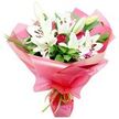 A rich and elegant bouquet featuring white Oriental lilies and deep red roses is shown against a plain white background, the sort of design you might receive through same-day delivery from Flowers Highgate. At the centre of the arrangement, several lilies bloom confidently, their large, trumpet-shaped petals a smooth, luminous white, gently curving back to reveal striking orange-brown stamens and clean, pale green filaments. The lilies appear in different stages of life: some fully open and star-like, others in tall, smooth buds with soft green tips, poised to open in the days after arrival and extend the bouquet's beauty. Between these striking white blooms, clusters of red roses add depth and romance, their petals tightly coiled in classic rosebuds or just beginning to peel back, revealing layers of velvety crimson. Around the central flowers, a generous amount of dark green foliage fills out the composition, combining broader, glossy leaves with fine, grass-like strands that arc upwards and outwards, creating a sense of natural movement that recalls the calm greenery of Waterlow Park on a quiet morning. The stems are wrapped in glossy bright pink cellophane, layered and shaped so that it forms billowing, translucent folds that radiate out around the blooms, catching little flashes of reflected light and giving the bouquet a celebratory, almost gift-wrapped feel right from the moment it is seen. At the base, a narrow lime green ribbon encircles the stems, tied neatly to provide a crisp, fresh contrast to the pink and green tones. The overall impression is one of thoughtful romance and joy, ideal for anniversaries, graduations, or simply sending love to someone special in Highgate without needing to say too much.