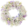 This photograph shows a serene, circular funeral wreath crafted from white and soft purple flowers, set against a crisp, white background that isolates every bloom and detail. The foundation of the wreath is a dense ring of Baby's Breath, with thousands of tiny Gypsophila blossoms creating a delicate, cloud-like texture that feels feather-light yet full. Resting on this airy base are numerous Lisianthus blooms, each with gently frilled petals. The petals are mostly white but finished with graceful edges and fine veins of lilac and violet, as if brushed with watercolour paint. Some flowers are fully open, their layered petals framing small, pale centres, while others appear as buds and half-open blooms in shades of soft green, cream, and faint yellow, lending an impression of life still unfolding. The middle of the wreath is an empty, clear circle, giving the arrangement a contemplative feel and symbolising the unending nature of love and memory. There is minimal visible foliage, ensuring the focus remains on the soothing partnership of white and purple. The entire composition feels quiet and composed, well suited to the reflective atmosphere of a funeral or memorial in Highgate, perhaps near the leafy paths of Waterlow Park or the historic gravestones of Highgate Cemetery. The clean background in the image draws the eye to the careful craftsmanship-how evenly the Baby's Breath is distributed, how thoughtfully the Lisianthus has been placed-so that the wreath conveys not only sympathy and respect but also the steady hand of an experienced local florist.