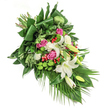 Designed with both artistry and empathy, this cascading floral tribute offers a harmonious blend of classic beauty and modern flair-qualities that echo within Highgate's vibrant community. Luxurious white lilies, some fully open to expose golden stamens, others still folded as potential amid fresh greenery, anchor the flow of the piece and evoke a spirit of calm remembrance. Soft pink and deep fuchsia roses unfold nearby, each one bringing a sense of affection and grace, while clusters of pristine white spray carnations add gentle texture and serenity. Moss-green santini chrysanthemums, playfully rounded, dot the spray with a contemporary accent and recall the fresh lawns seen in Highgate Cemetery. Scarlet red hypericum berries, small and lustrous, are strategically interspersed, enlivening the palette against dense, glossy leaves and sweeping palm fronds that extend the spray's organic motion. Under soft, diffused morning light, all colours appear luminous, their interplay suggesting peace and heartfelt condolence. This arrangement feels created for significant moments-a final tribute, a sympathy expression, or a memorial gesture delivered thoughtfully across Highgate and its neighbouring streets, inviting quiet reflection through every considered detail.