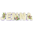 A deeply reverent floral tribute formed into five bold, three-dimensional letters spells JENNA across a clean white ground. Each letter is densely covered in tiny, creamy white chrysanthemums - or similar small blooms - layered so closely they read like soft snowdrifts, the surface gently ruffled by petal edges and light. A fine band of purple or lavender trim runs along the inner curves and bases of each letter, a delicate outline that gives the composition definition and a quiet, dignified contrast to the white. Three small accent clusters break the white plains with gentle colour: blush-pink and lavender spray roses, a few paler cream or soft yellow buds, and slim fronds of deep green fern tucked into the J, the centre of the first N, and the upper right of the A. The roses carry a subtle sweet perfume against the green, while the chrysanthemums offer the soft, almost powdery scent of a chapel bouquet. Thin, dark linking bars are visible beneath the blooms, evidence of careful structural work that keeps the letters level for display at a chapel, wake, or graveside. The overall effect is one of serenity and careful craftsmanship - a personalised sympathy piece that reads clearly from the front pews and the path around Highgate Cemetery or a quiet corner of Waterlow Park. A local florist's hand is evident in the balanced placement of colour and the tactile contrast between cloud-white flowers and the deeper purple edging, creating a lasting, personal farewell that feels both composed and full of feeling.