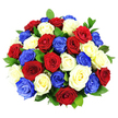 A tightly gathered, domed bouquet of roses in red, white, and blue takes centre stage, its colours vivid and symbolic against a clean, white background. The roses are numerous and densely arranged, each bloom fully open and revealing spirals of soft, velvety petals. Deep red roses bring richness and gravitas, their tones echoing sentiments of love, respect, and remembrance. The white roses, pure and bright, offer a peaceful counterpoint, their petals slightly cupped and luminous under the clear studio lighting. Vivid cobalt blue roses add a bold, contemporary flourish, their unexpected hue suggesting celebration and modern style, as striking as festive ribbons hung around Highgate Village during national events. Small glimpses of dark green foliage appear between the blossoms, the leaves glossy and healthy, adding depth and an organic feel to the otherwise precise composition. The bright, even lighting clearly defines each petal edge and the subtle texture of the greenery, while gentle shadows lend a sense of three-dimensionality to the rounded form. There is no visible vase or surrounding decor, so the bouquet looks almost as if it is being held up for admiration in a Highgate florist's studio. The careful distribution of red, white, and blue across the dome creates a balanced, emblematic look, evoking themes of unity, honour, and shared identity. It is easy to imagine this bouquet placed on a central table at a patriotic gathering, a remembrance service, or a milestone celebration in a Highgate home, where its strong colours and classic roses would serve as a heartfelt floral tribute.
