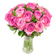 As a florist describing this arrangement to someone who cannot see it, I would begin with the overall silhouette: roughly two dozen pink roses gathered into a dense, domed bouquet that reads as generous and intimate at once. Each bloom is at its peak, the petals layered in a classic spiral, with colour flowing from a rich fuchsia or magenta in the tightly furled center out to softer blush pinks and the palest creamy-white at the outermost edges. The roses are so closely placed that the eye-and the hand-encounters a continuous surface of petals, with occasional dark green leaves peeking through to give breathing space and sculptural contrast. The stems are neatly trimmed and visible through a clear, slightly curved glass vase filled with water; you can almost hear the faint clink and sense the coolness of the glass and liquid below. Lighting is bright and even in the photograph, bringing out the satiny sheen of each petal and small highlights along each curve, while the pristine white background lifts the colours so they pop with fresh intensity. I imagine the scent as gently fruity and green, a soft perfume that hangs above the bouquet like a memory of an English garden at dawn. This arrangement conveys classic romance and celebratory warmth-ideal for anniversaries, a Mother's Day tribute, or a thoughtful congratulations. Locally, I picture it sitting on a windowsill overlooking Waterlow Park or on a mantel in a Highgate Village flat, a floral gesture that feels both timeless and lovingly made by someone who cares about every bloom.